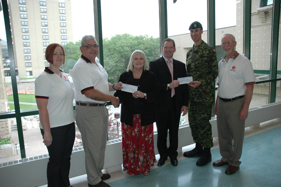 Pictured from left - Brandon Salutes representatives Lori Truscott, Chuck LaRocque, Brandon University President Dr Deborah Poff, Assiniboine Community College interim President Jim Brinkhurst, Heroes' Gala rep Major Ludget Hacault, and Brandon Salutes Chair Steve Morrison.