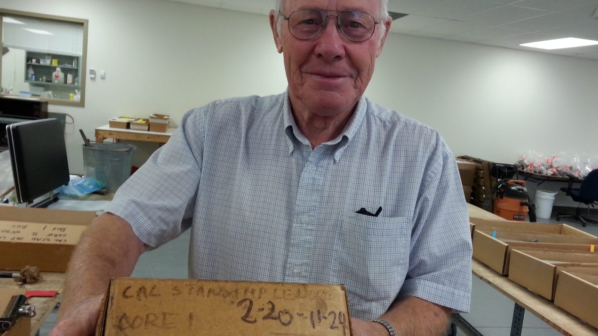 A man in a laboratory holds a box