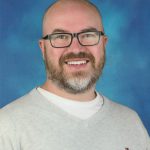 A man smiles