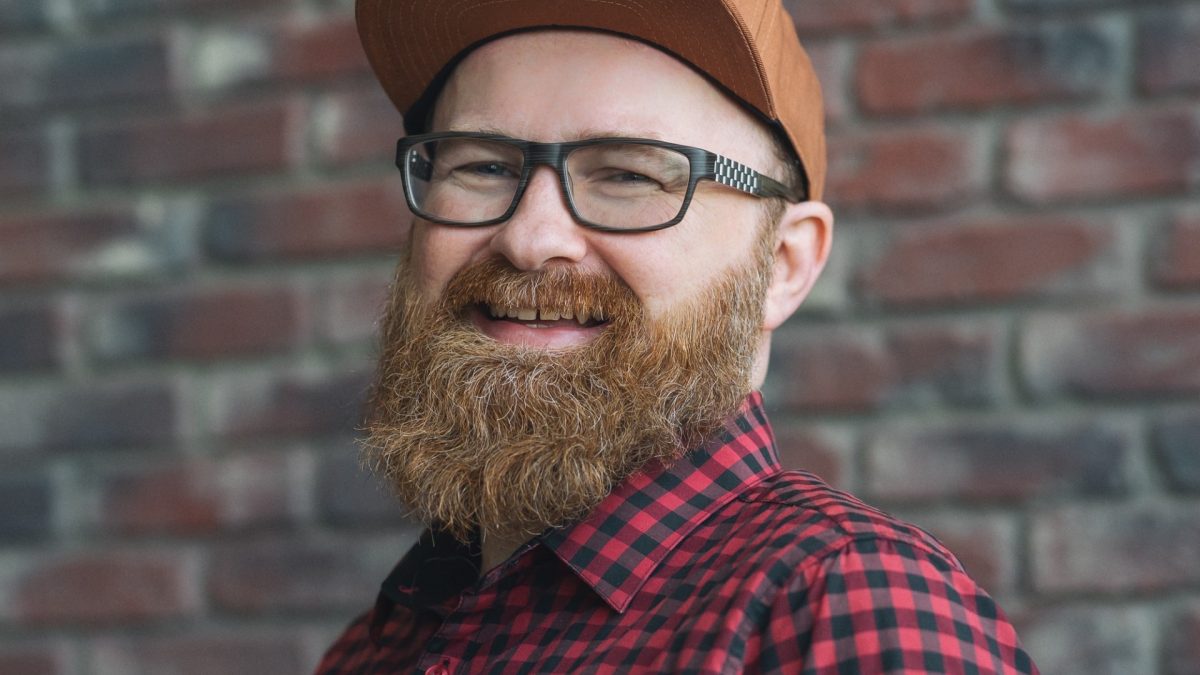 A man in glasses and baseball hat, with a beard.