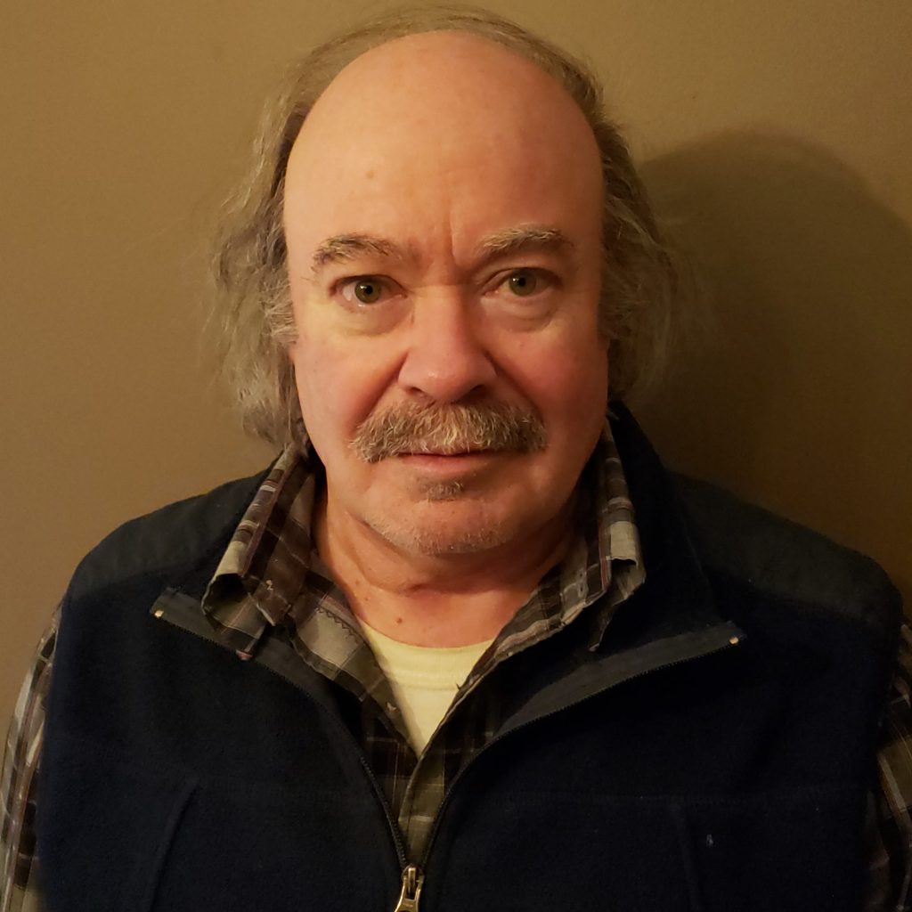 Headshot of a man with a moustache.
