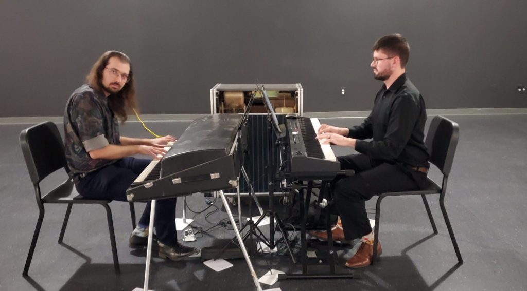 Two keyboardists perform