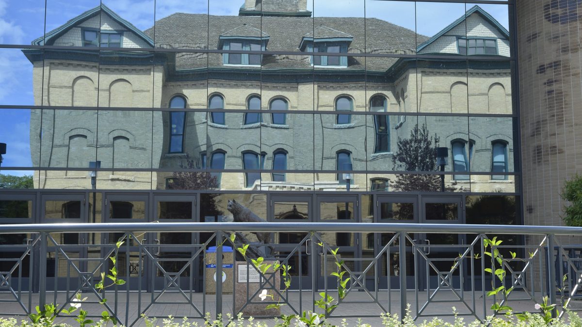 Reflected Clark Hall in the glass of the library