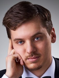 Heads shot of a man with has hand in his face in a thoughtful pose