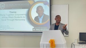 A man gestures at a podium.