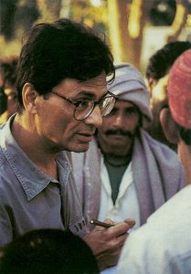 Vintage photo of a young man speaking in a crowd.