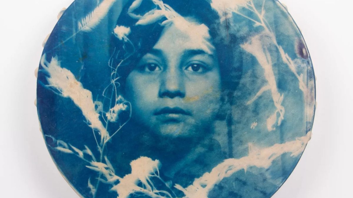 Round image of a weathered-looking photograph of a girl