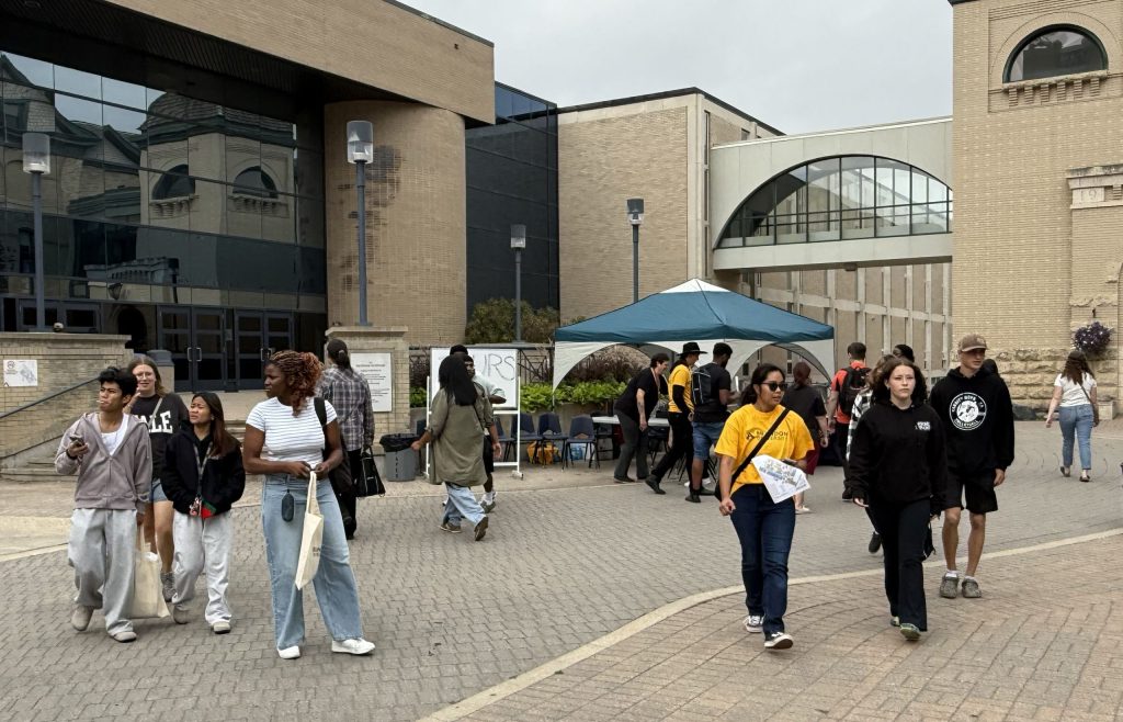 A group of people walk around a courtyard