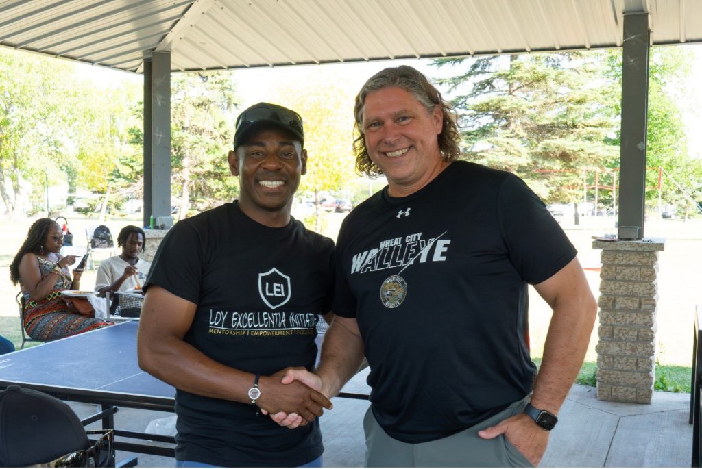 Two men shake hands