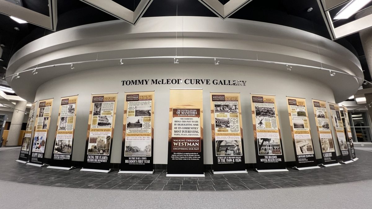 A group of pop-up displays in front of a sign that says Curve Gallery.