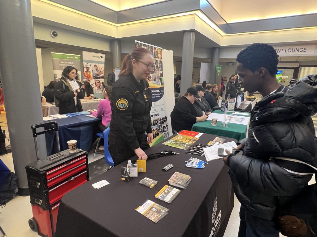 Students connect with employers at a kiosk.