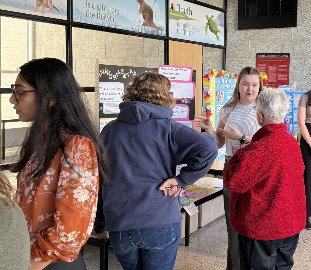 A woman speaks to a group of people.