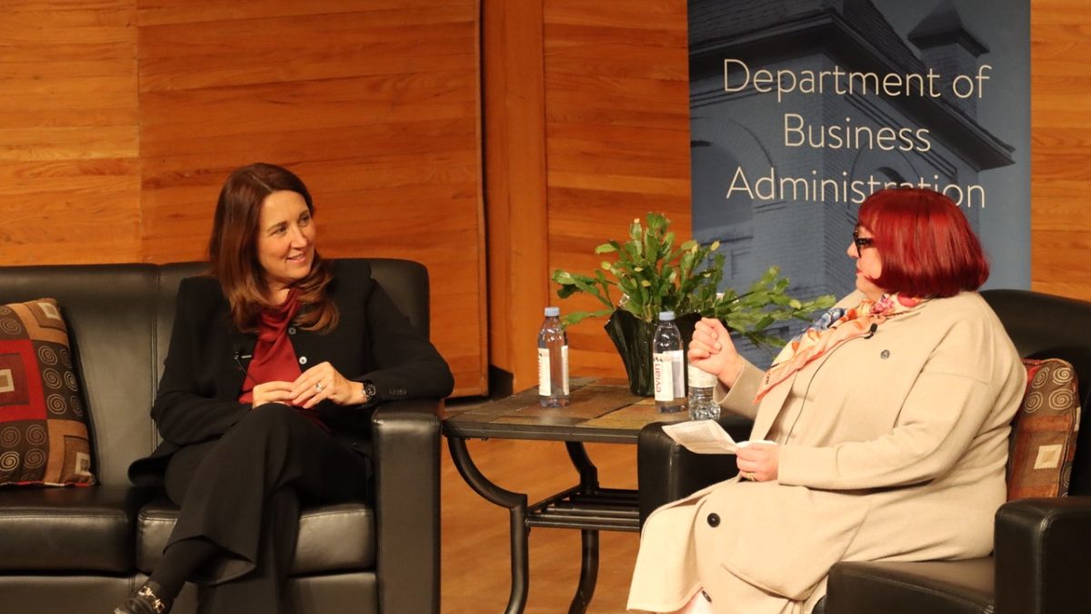 Two women have a discussion on stage.