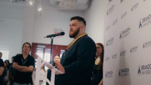 A man with a beard at a podium