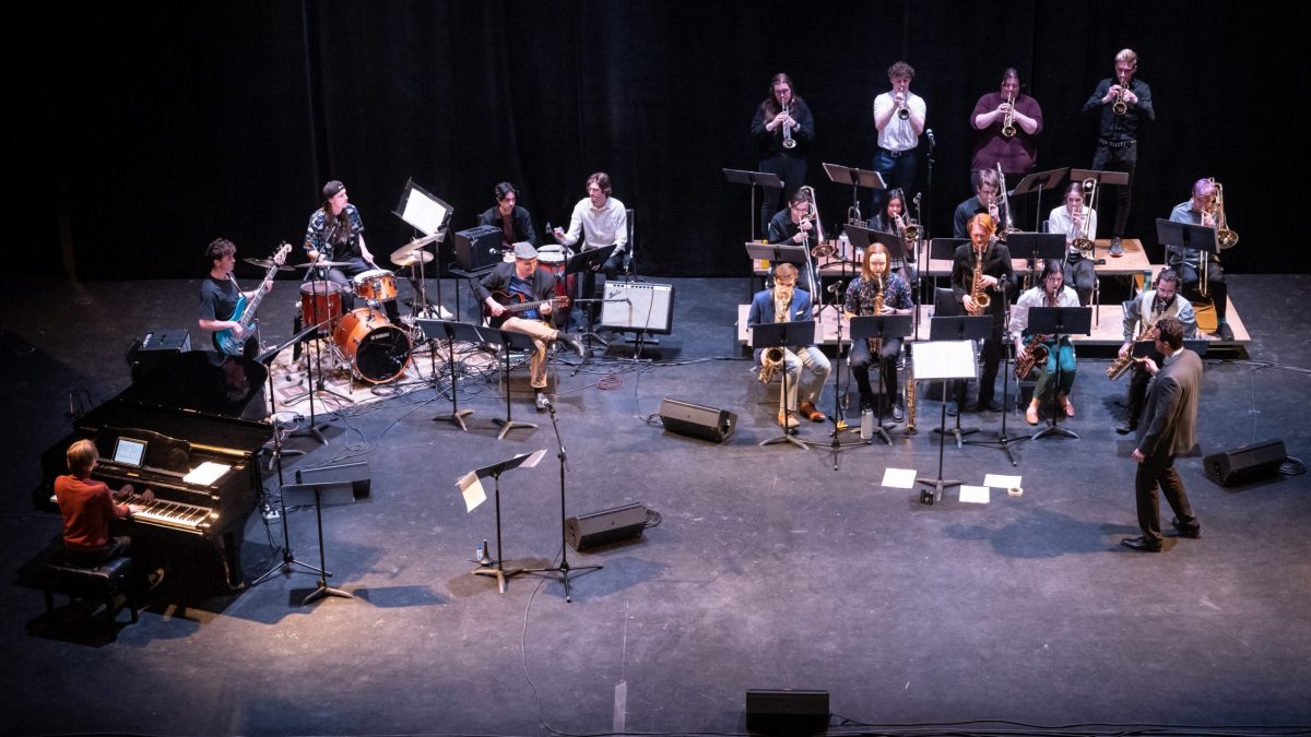 A large jazz group performs on stage.