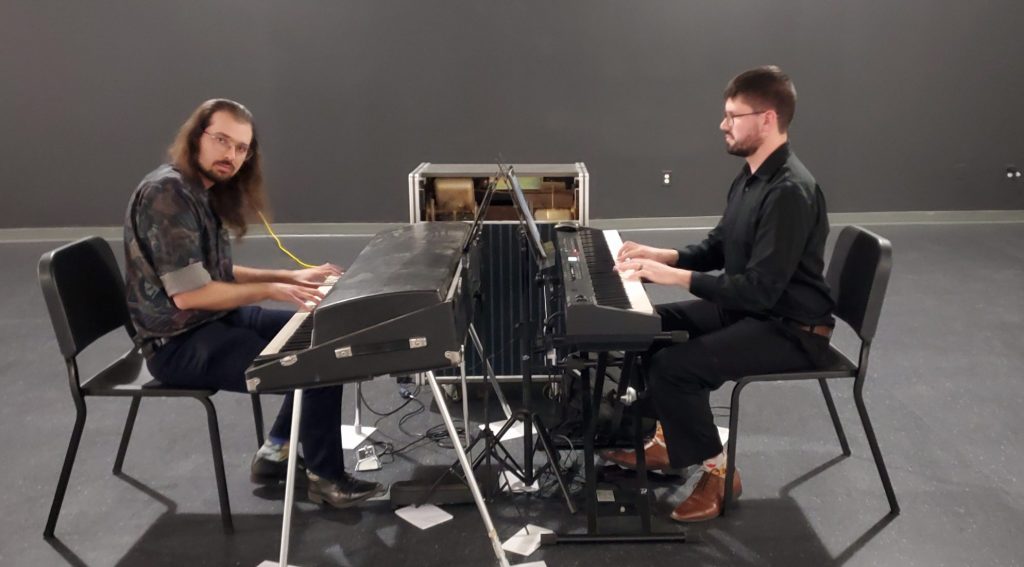 Two keyboardists perform