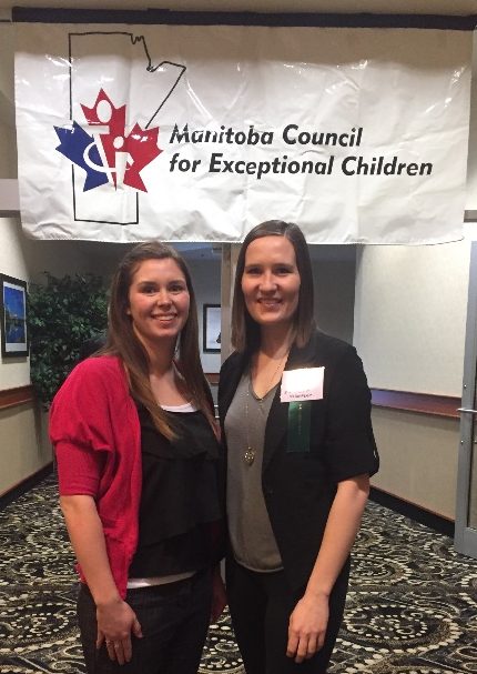 Cochrane and Drummond pose below and in front of a banner for the Manitoba Council for Exceptional Children