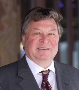 Headshot of a man in a suit