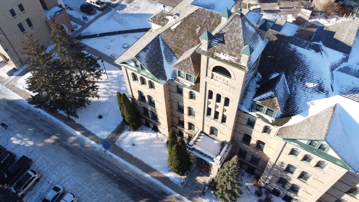 Aerial view of Brandon University's Clark Hall, looking down at a winter scene.