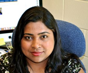 Dr. Majumder sits with a computer monitor behind her