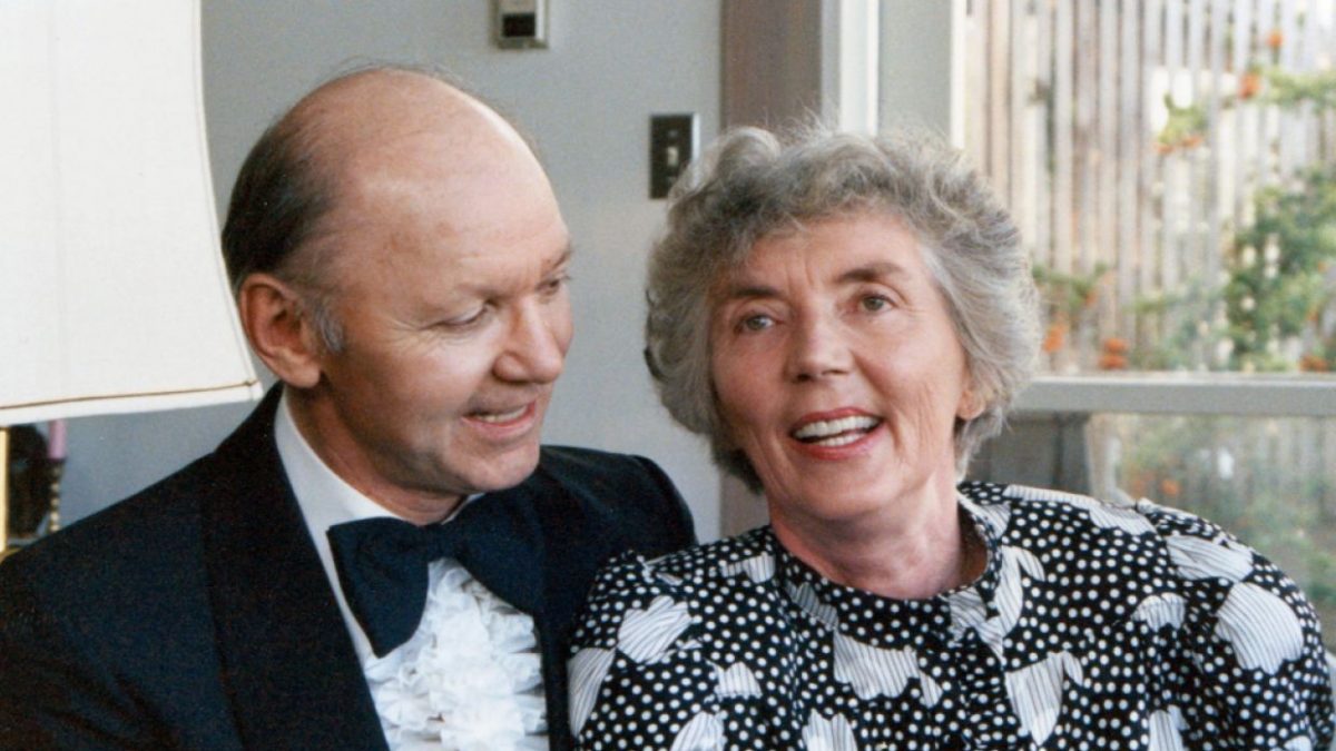 A smiling couple look at each other