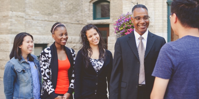 Dr. Gervan Fearon with students, 2014 (web banner)