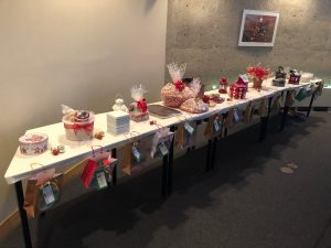 A long table features several gift-wrapped prizes.