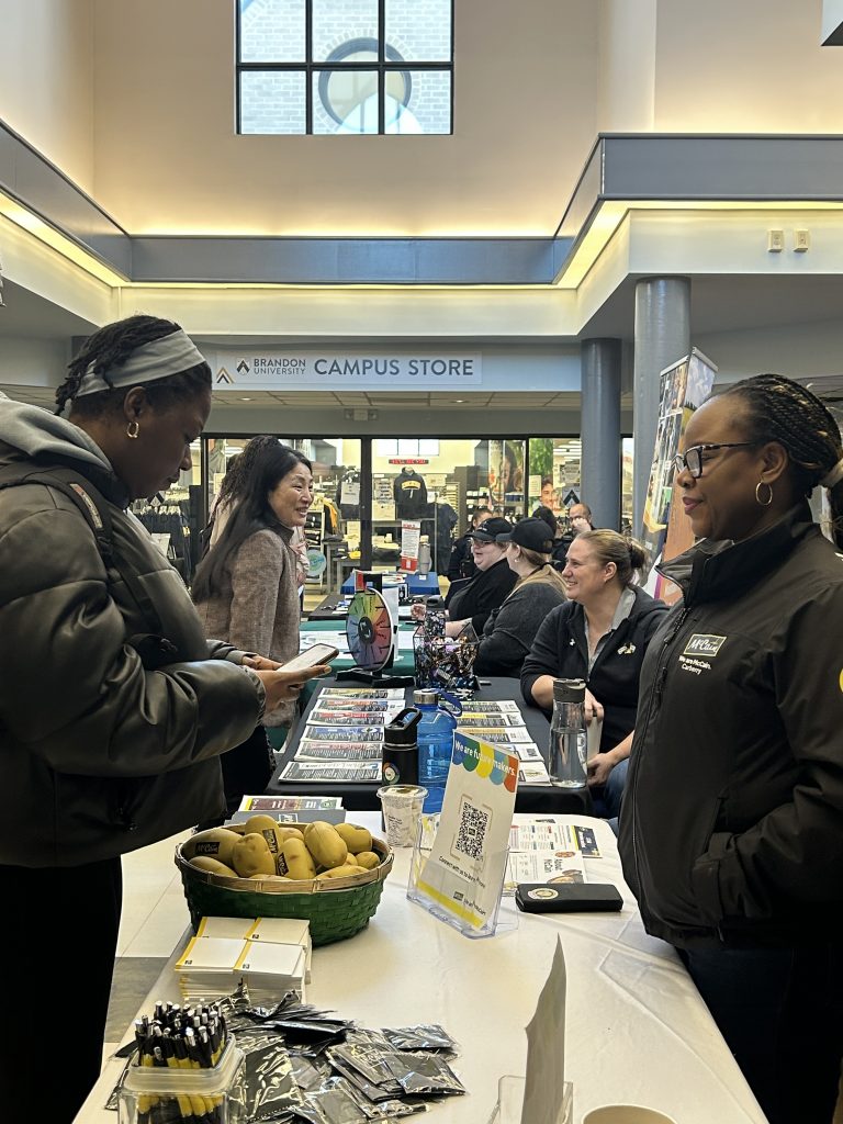 Students connect with employers at a kiosk.