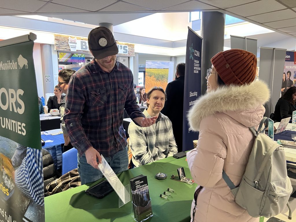 Students connect with employers at a kiosk.