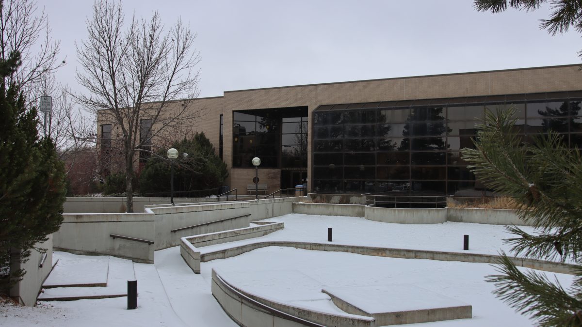 A building behind an amphitheater on a snowy day