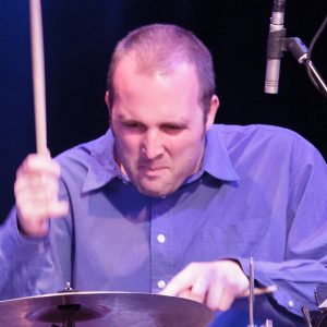 Close-up photo of Nick Fraser playing a cymbal