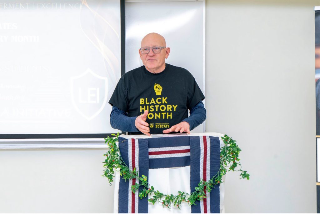 A man speaks at a lectern