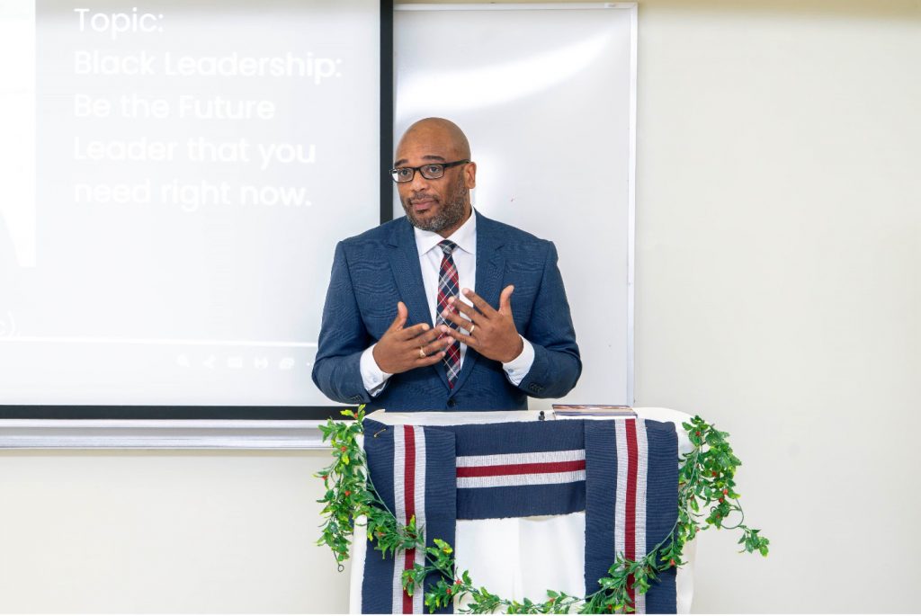 A man speaks at a lectern