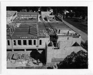 Black and white photo of a large construction site.