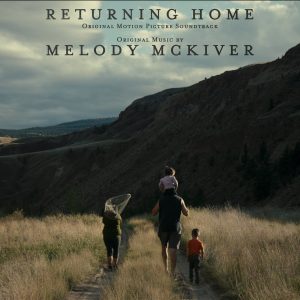 Album Art for the Returning Home soundtrack shows four people on a trail. One of them is a child being carried by an adult. Another person is carrying a fishing net.