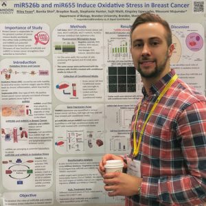 A man holds a coffee cup while standing next to a research poster