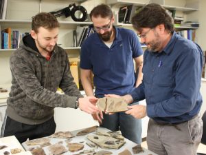 Students Cale Gushulak and Christopher West with Dr. David Greenwood viewing McAbee fossils