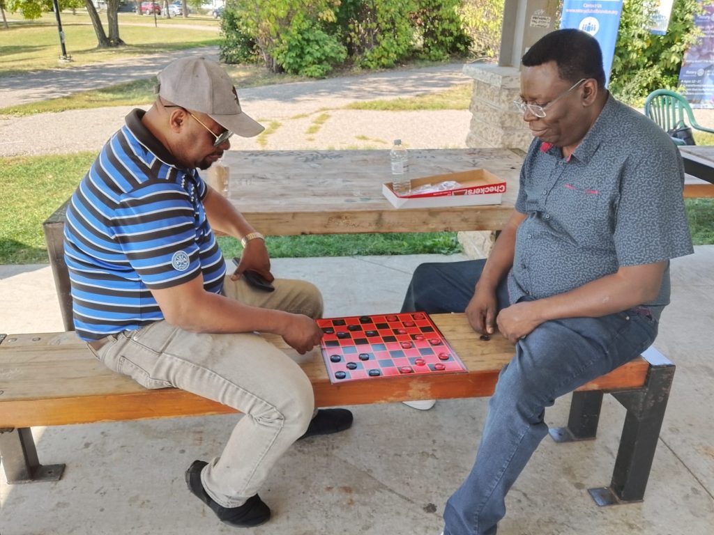 Two people play checkers